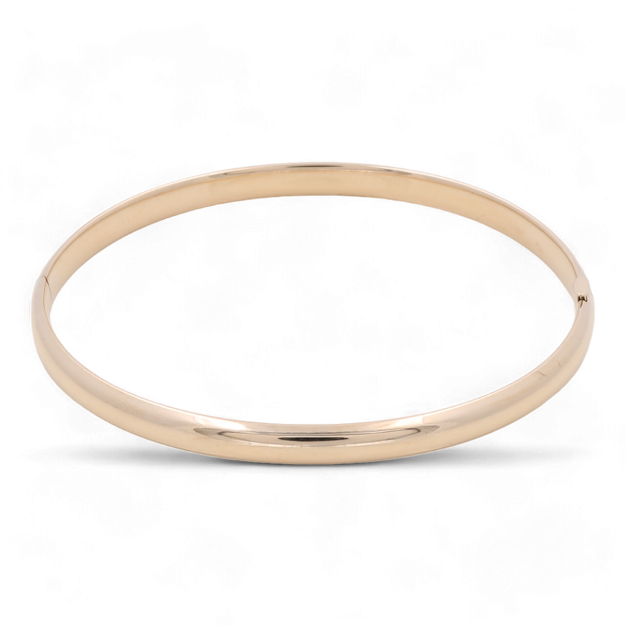 A delicate 14K Yellow Gold Fashion Bangle by Miral Jewelry showcased against a white background.