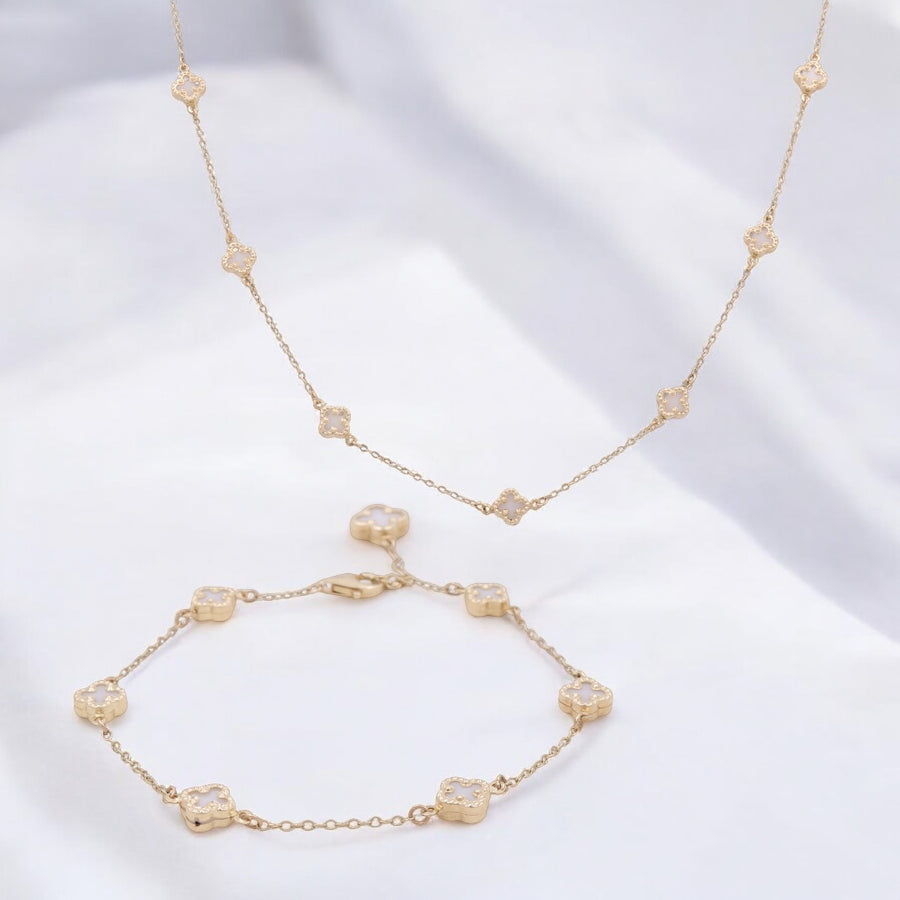 Miral Jewelry's 14K Yellow Gold Fashion Clover with Mother of Pearl Set, featuring a stunning necklace adorned with small, evenly spaced clover-shaped pendants and a matching gold bracelet, showcased on a white background.