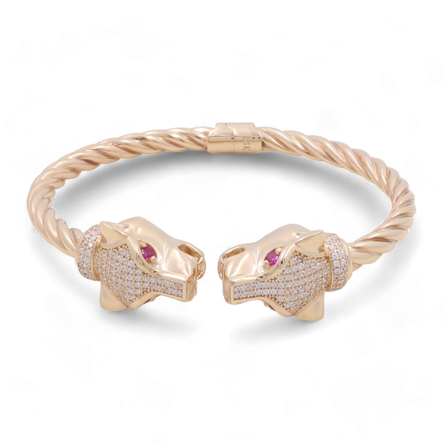 The Miral Jewelry 14K Gold Fashion Panther with Color Stones and Cubic Zirconias Bracelet is a true statement piece, featuring two intertwined panther heads with red gemstone eyes, encrusted with small diamonds.