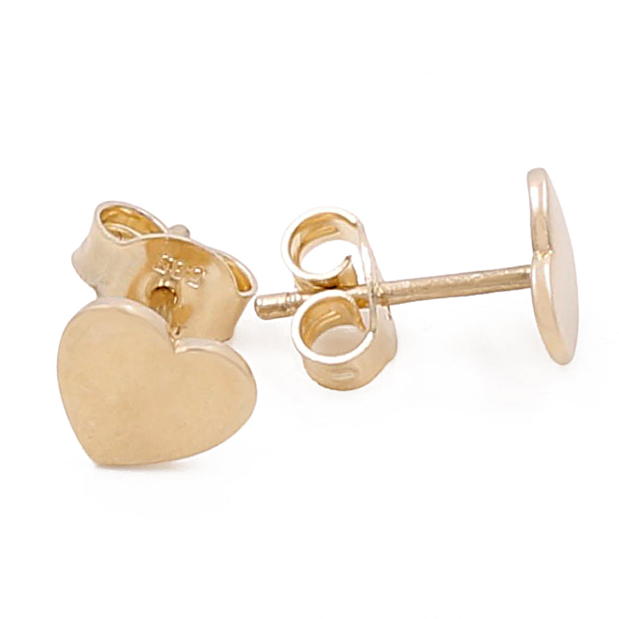 Gold heart-shaped stud earrings with butterfly backings, crafted from 14k yellow gold, displayed against a white background. This luxury jewelry piece, the 14k Yellow Gold Hearts Earrings from Miral Jewelry, exudes timeless style and elegance.