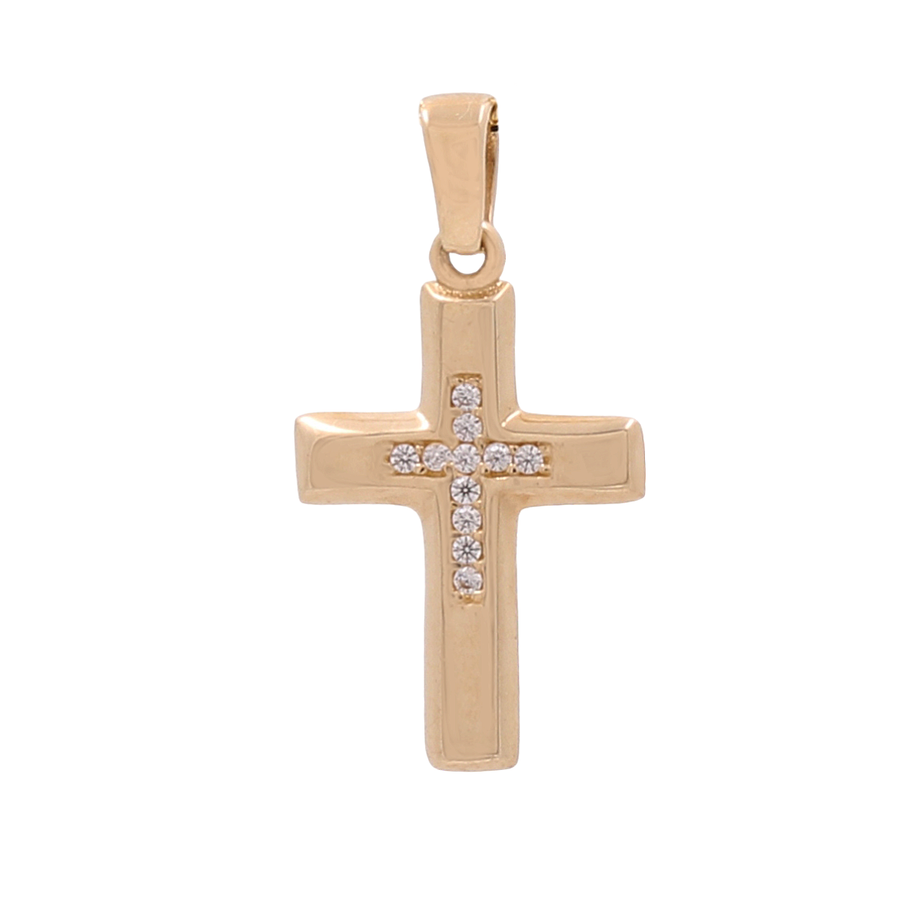 The Miral Jewelry 14K Yellow Gold Fashion Cross Pendant showcases a striking design with cubic zirconias beautifully embedded in a vertical line at its center.