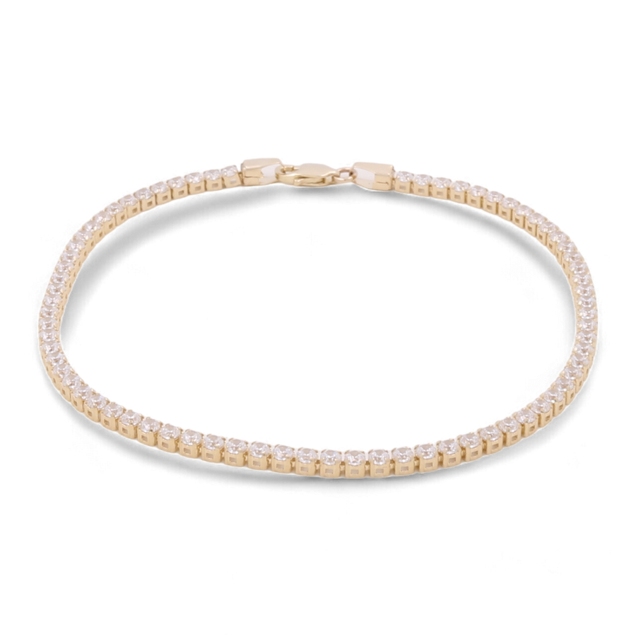 Introducing the 14K Yellow Gold Fashion Tennis Bracelet from Miral Jewelry, featuring small, evenly spaced cubic zirconias and a secure clasp closure.