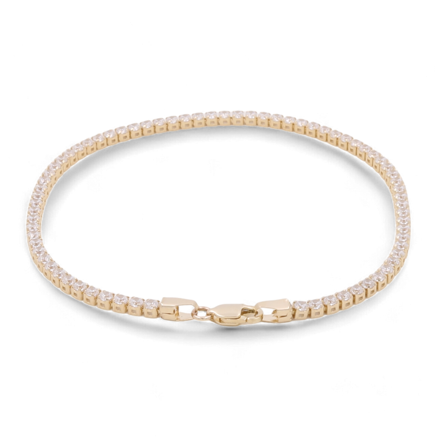 The Miral Jewelry 14K Yellow Gold Fashion Tennis Bracelet features small cubic zirconias around the band and includes a secure clasp.