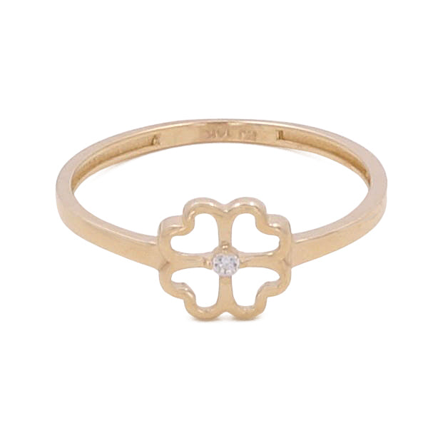 The 14K Yellow Gold Women's Fashion Clover Ring by Miral Jewelry features a delicate four-leaf clover design with a small central diamond, flanked by dazzling cubic zirconias on a thin band, making it a timeless accessory.