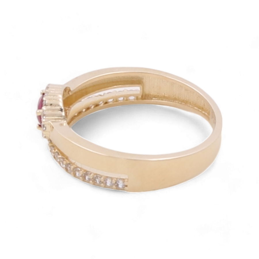 The 14K Yellow Gold Women's Fashion with Color Stone Ring by Miral Jewelry showcases a round red gemstone in the center, complemented by smaller clear cubic zirconias on either side, all beautifully displayed against a white background.