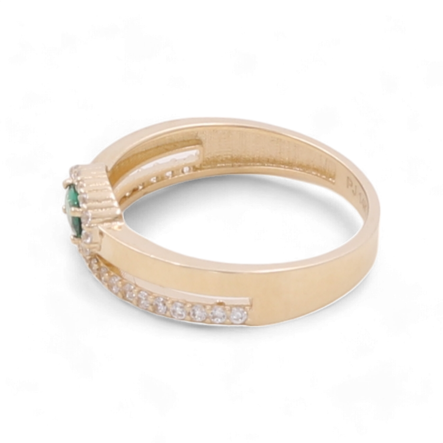 The Miral Jewelry 14K Yellow Gold Women's Fashion with Color Stone Ring features a vibrant green stone and several small clear cubic zirconias embedded along part of the band.