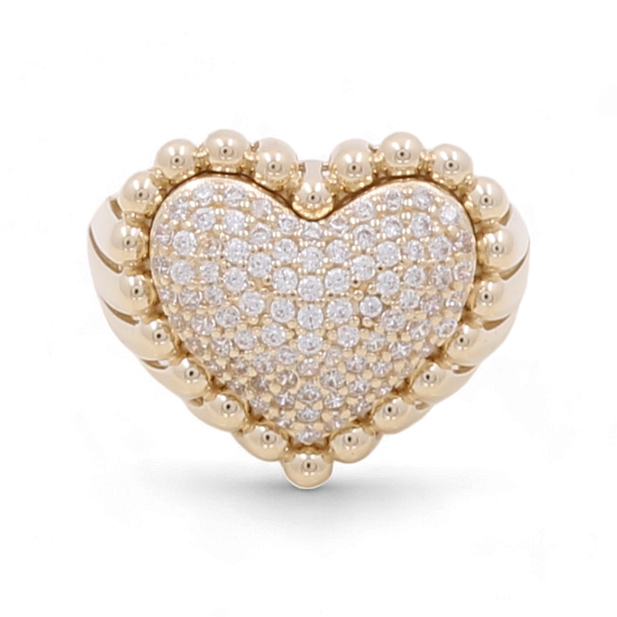 The 14K Yellow Gold Women's Heart Ring with Cubic Zirconias by Miral Jewelry features a heart-shaped design crafted from 14K yellow gold, adorned with numerous small cubic zirconias and bordered by round gold beads.