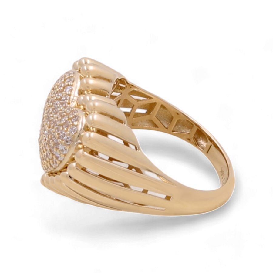 A striking 14K yellow gold women's heart ring by Miral Jewelry, featuring an intricate openwork band and a round face adorned with cubic zirconias.