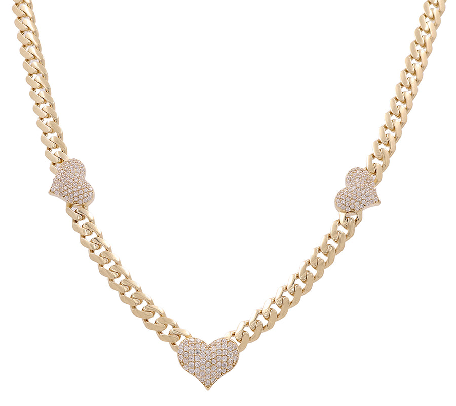 Discover the elegance of our jewelry collection with this 14K yellow gold chain necklace, adorned with three heart-shaped pendants encrusted with small sparkling stones. The Miral Jewelry 14K Yellow Gold Fashion Hearts Necklace with Cubic Zirconias is a timeless addition to any outfit.