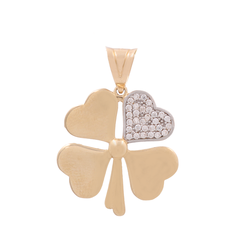 A 14K yellow gold heart treble women's pendant by Miral Jewelry with one leaf encrusted with small, clear CZ stones.