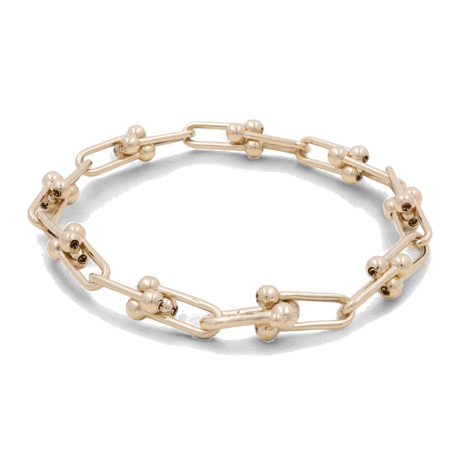 The 14K Yellow Gold Fashion Link Bracelet from Miral Jewelry exudes elegance with its angular links, each adorned with two small gold spheres. This fashion tennis bracelet is designed to dazzle, effortlessly blending sophistication and modern style.