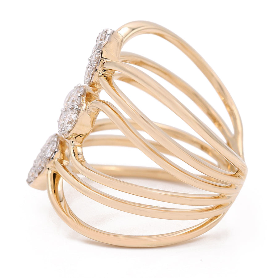 An exquisite women's fashion ring by Miral Jewelry, crafted from 14k yellow gold and featuring three bands adorned with diamond clusters, is showcased against a white background.