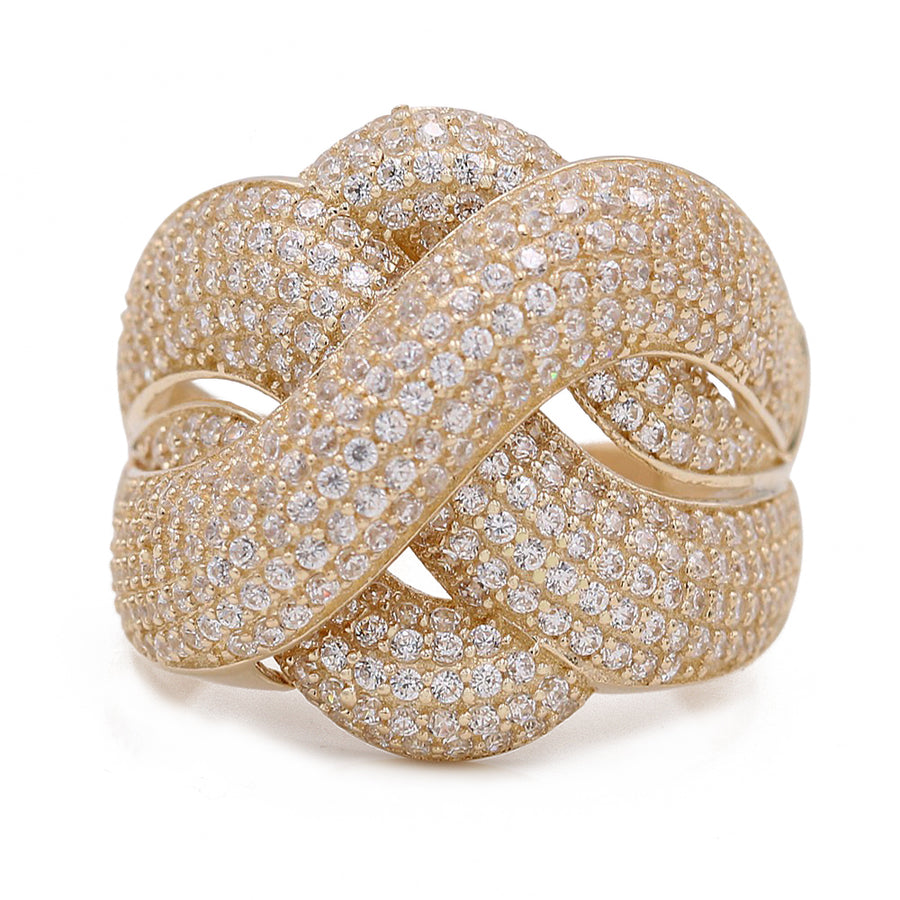 A Yellow Gold 14k Fashion Ring by Miral Jewelry, intricately designed with a knotted pattern and encrusted with numerous small sparkling cubic zirconia stones.