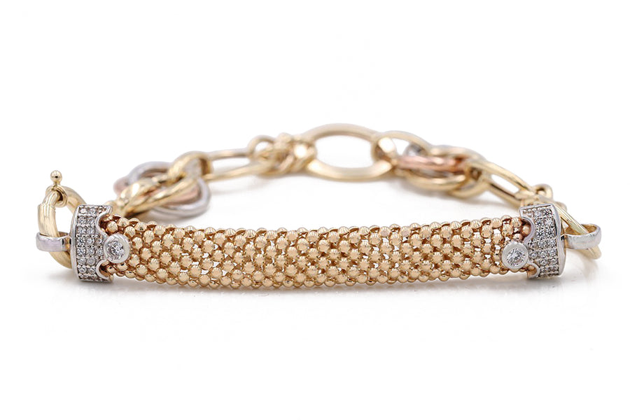 The Two Tone White and Yellow Gold 14k Mesh Bracelet by Miral Jewelry is a stunning piece featuring a woven texture and diamond accents at both ends, complete with an interlocking chain and clasp. This women's gold bracelet showcases elegance with its intricate design.